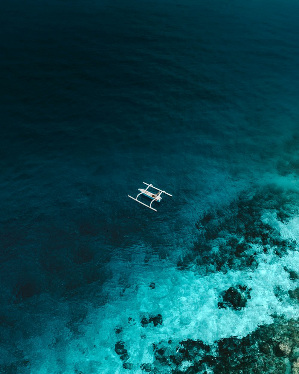 Traditional boat over turquoise water off Lombok's coast